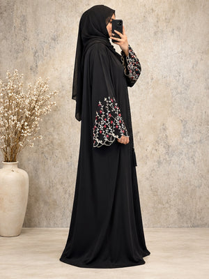 side view of a premium black open abaya with floral embroidered sleeve detailing