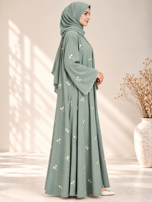 Side view of mint open abaya with elegant floral embroidery and matching scarf
