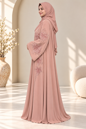Side view of dusty blush pink Reem open abaya showcasing its elegant stone work