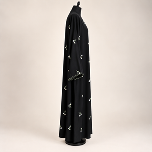 Front view of a black closed abaya with delicate dainty floral embroidery and matching scarf