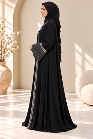 Side view of black abaya showcasing its elegant silhouette and organza balloon sleeves