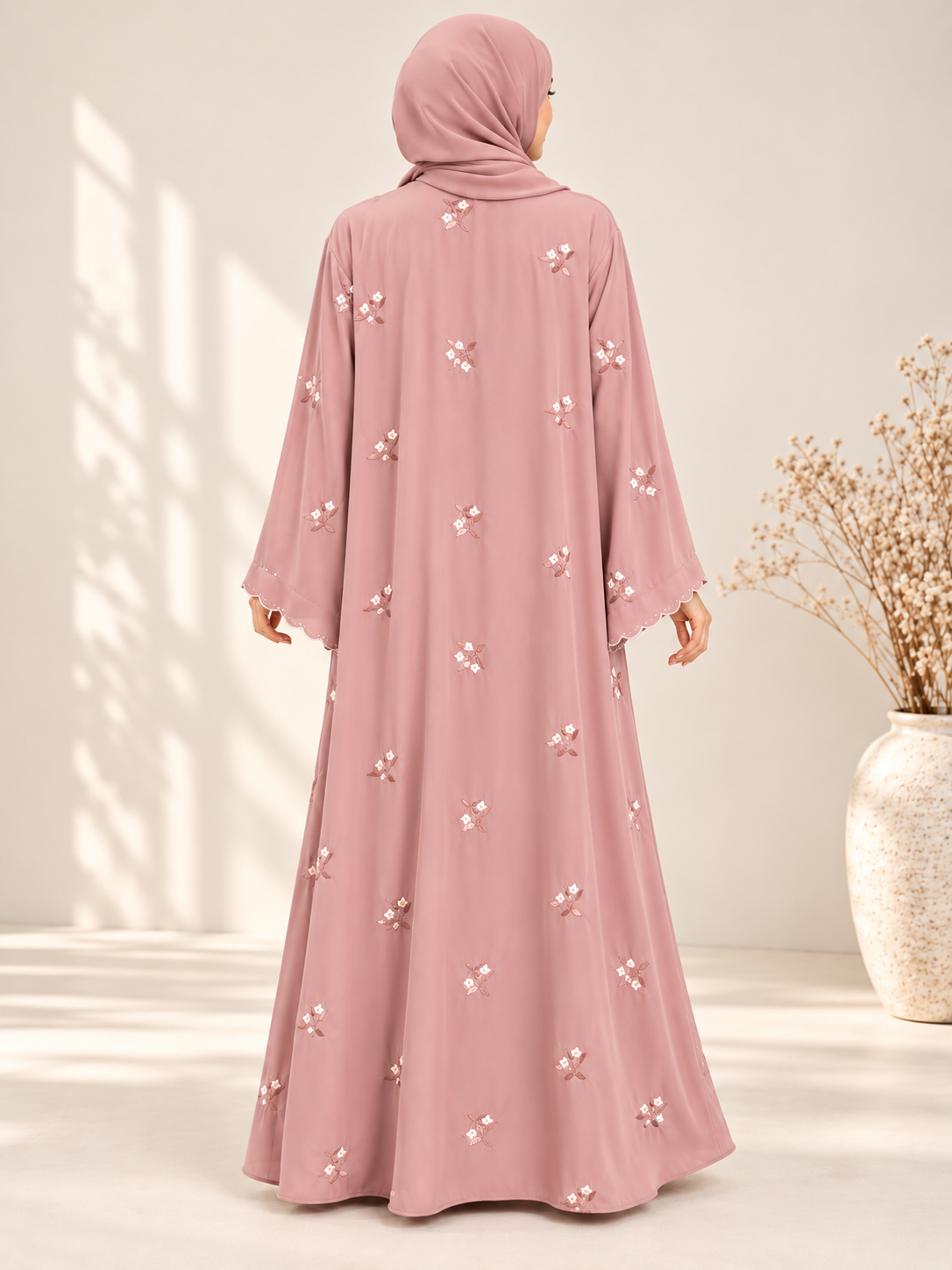 Back view of pink open abaya featuring delicate floral embroidery and matching scarf