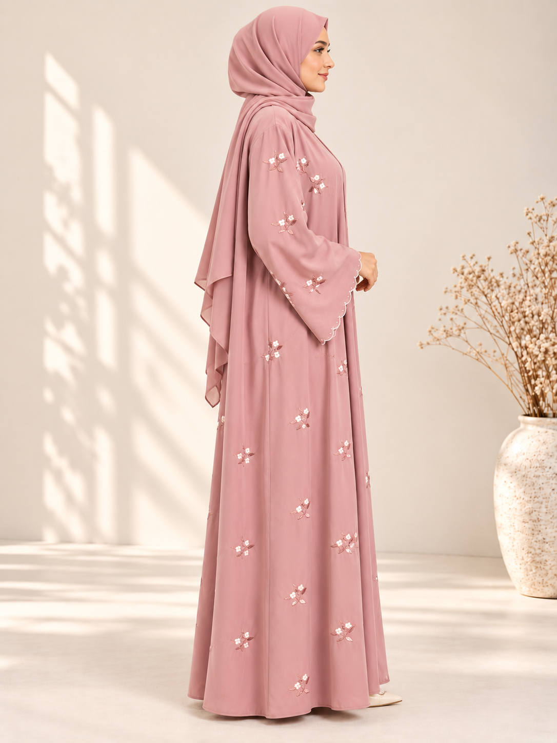 Side view of pink open abaya with elegant floral embroidery and matching scarf
