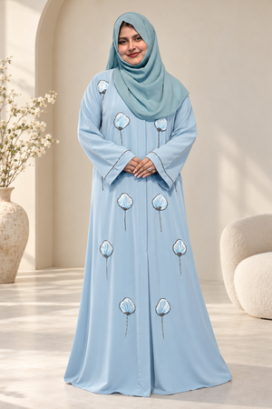 Model wearing a premium icy-blue open abaya with 3D floral embroidery and stone detailing, paired with a matching hijab.