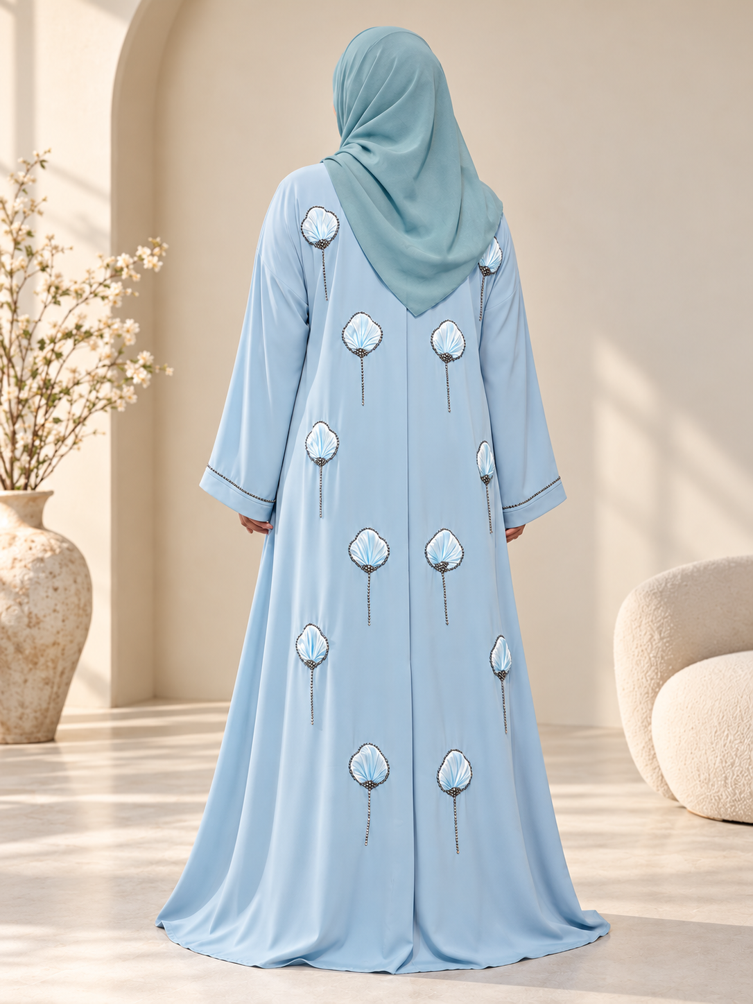 Back view of a premium icy-blue open abaya featuring 3D floral embroidery with stone detailing and a matching hijab.